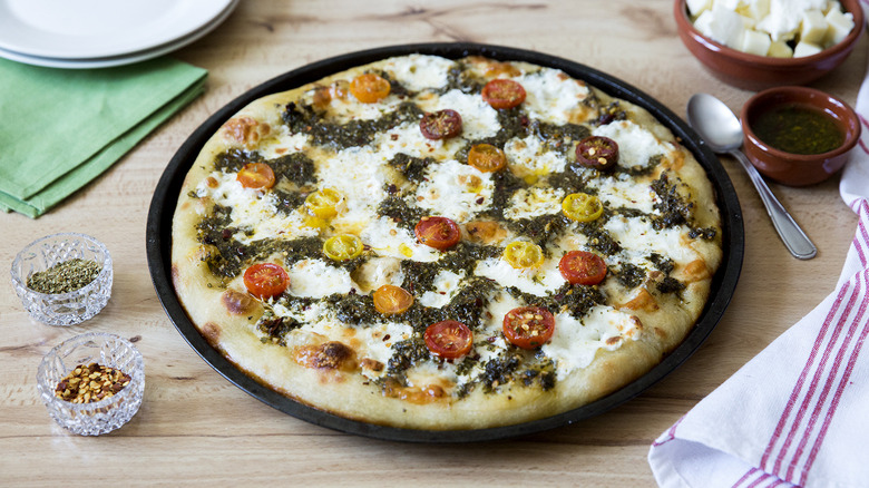 chimichurri tomato pizza on table