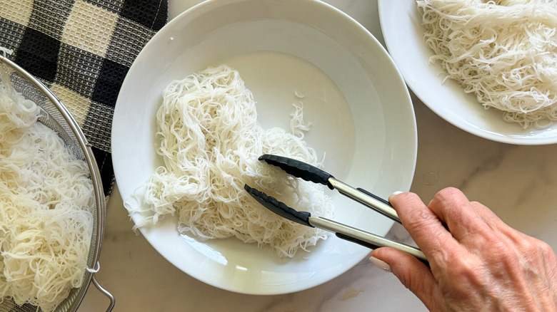 adding noodles to bowl
