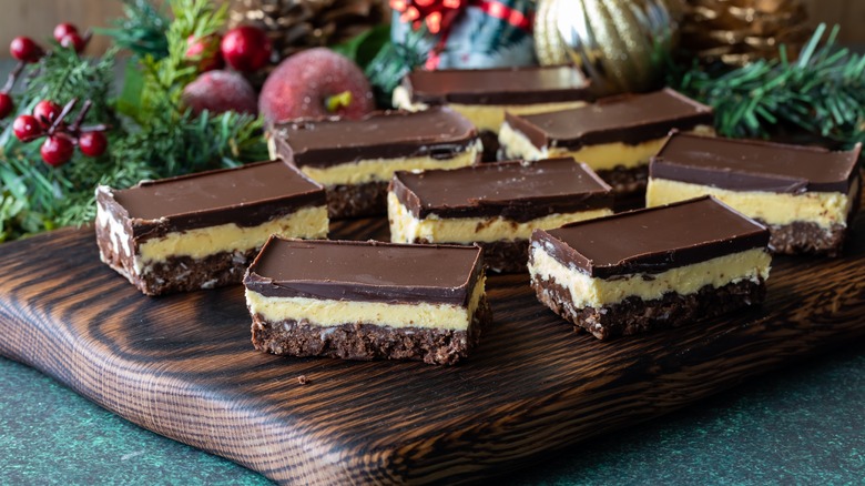 Nanaimo bars on wooden board