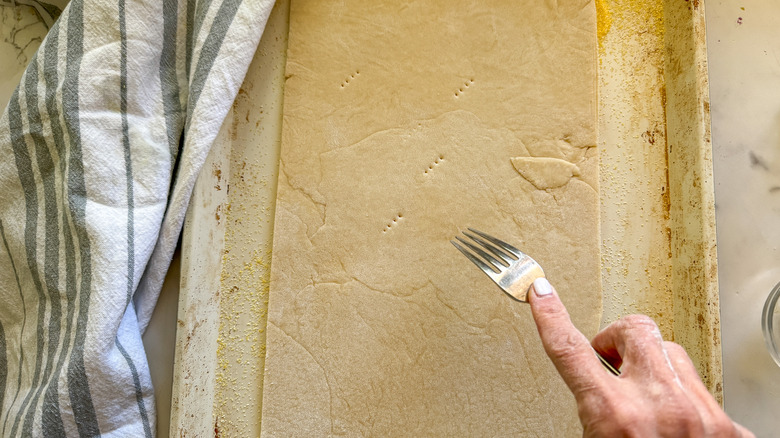 piercing dough with fork