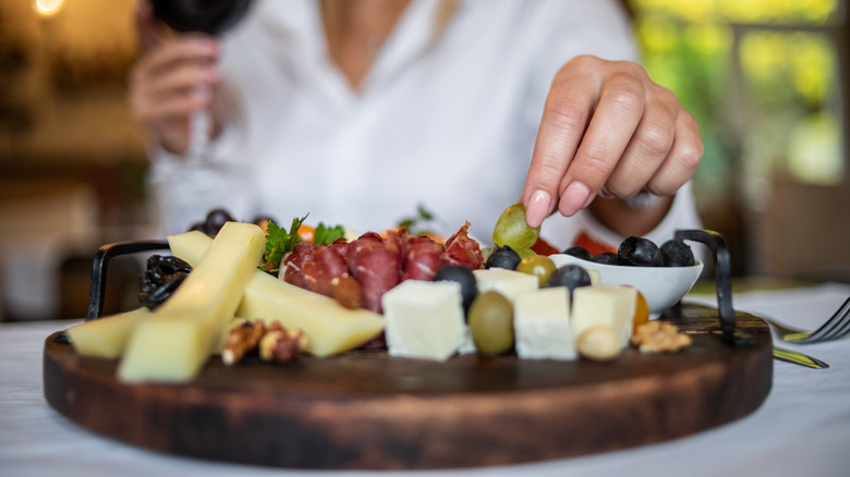 Person enjoying a charcuterie board