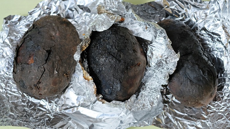 Char covered potatoes in foil