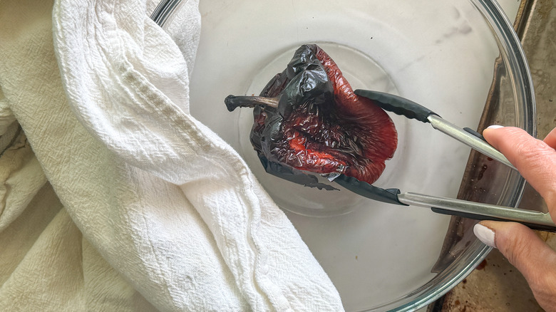 hand putting pepper in bowl