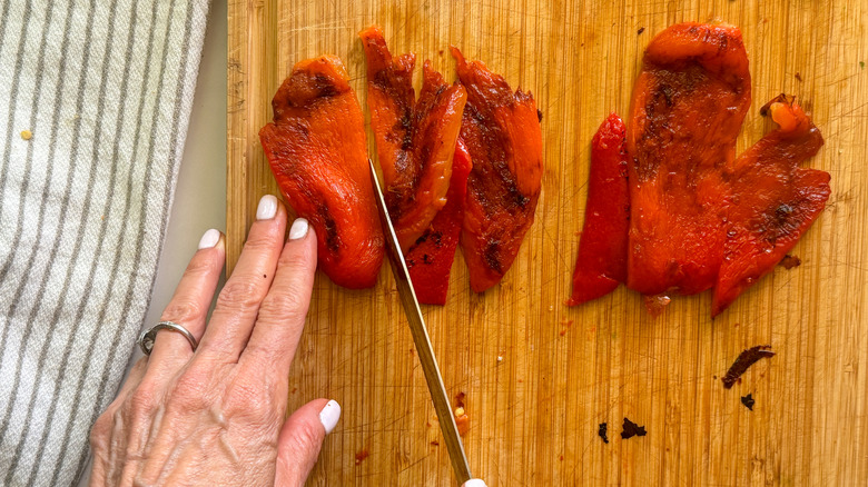 hand slicing red pepper