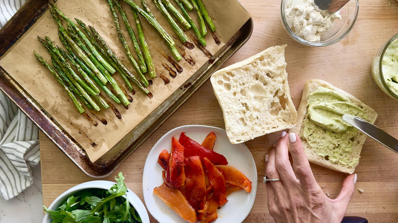 spreading pesto mayo on roll