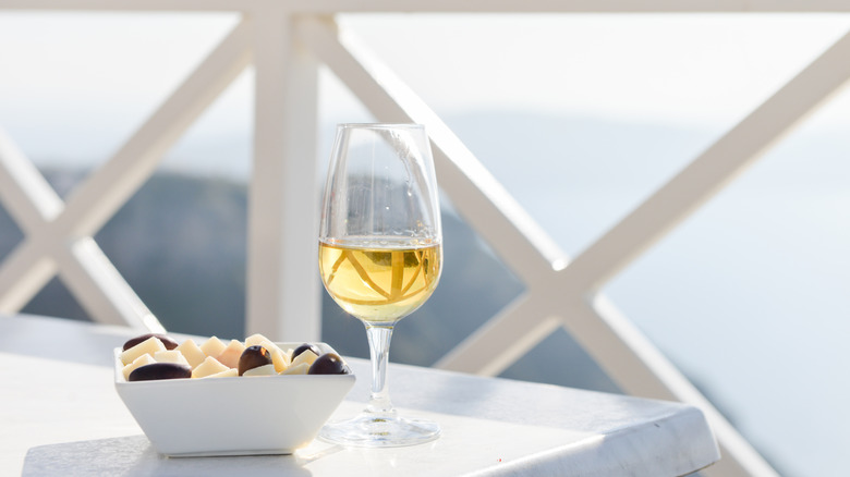 glass white wine on coastal terrace