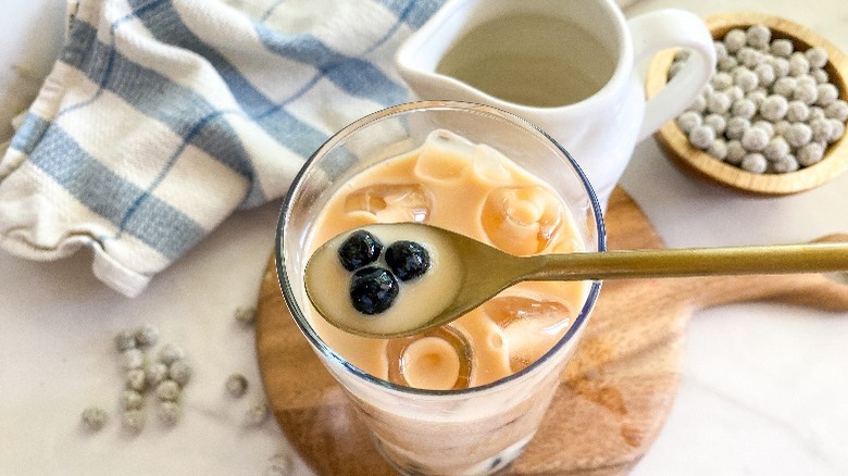 boba tea with spoon holding 3 boba pearls