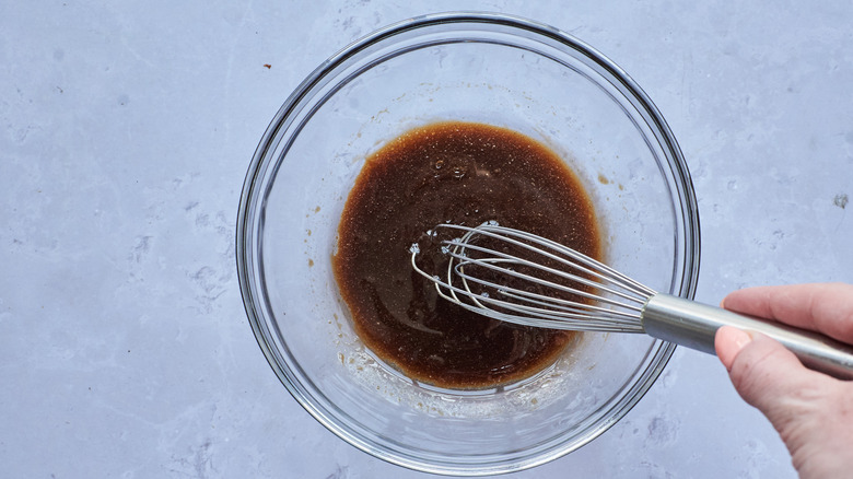 whisking sauce in bowl