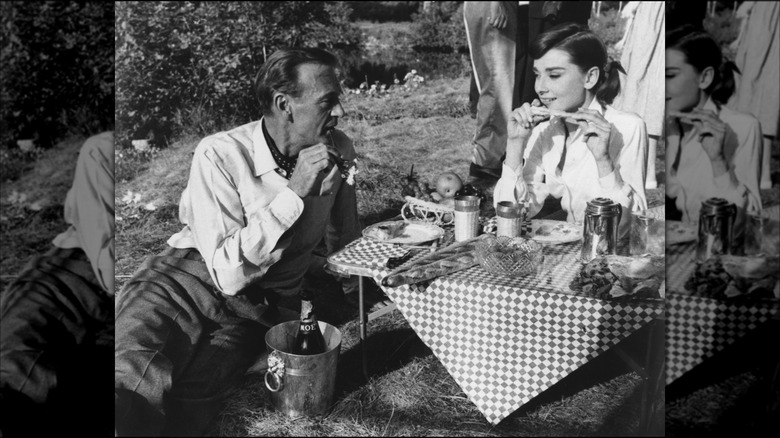 Audrey Hepburn and Gary Cooper picnicking on the set of "Love in the Afternoon" 