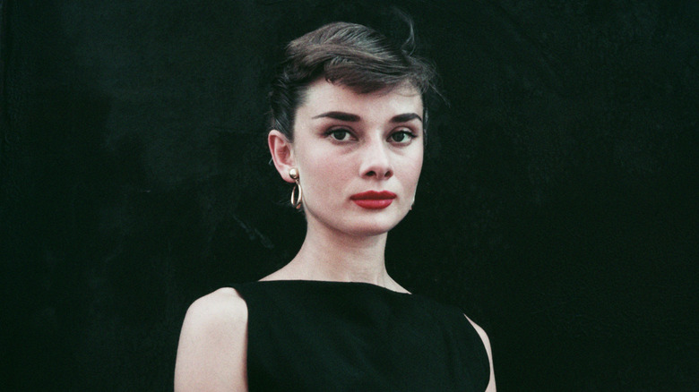 Audrey Hepburn posing for photographs