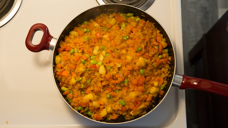 colorful veggies cooking in pan 