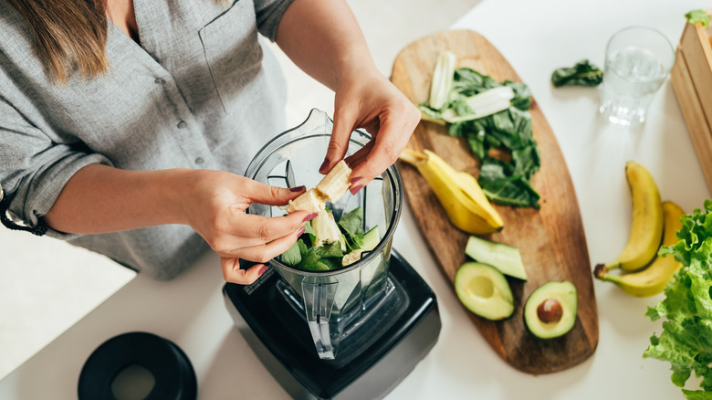 Woman preparing a smoothie