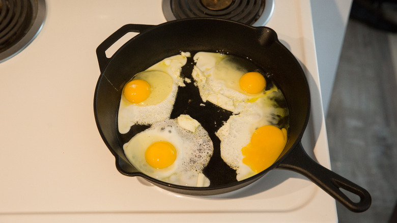 4 eggs frying in pan