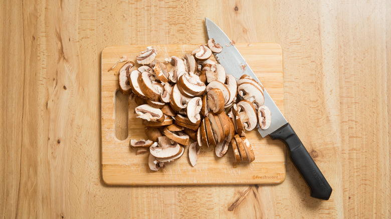 sliced mushrooms on cutting board
