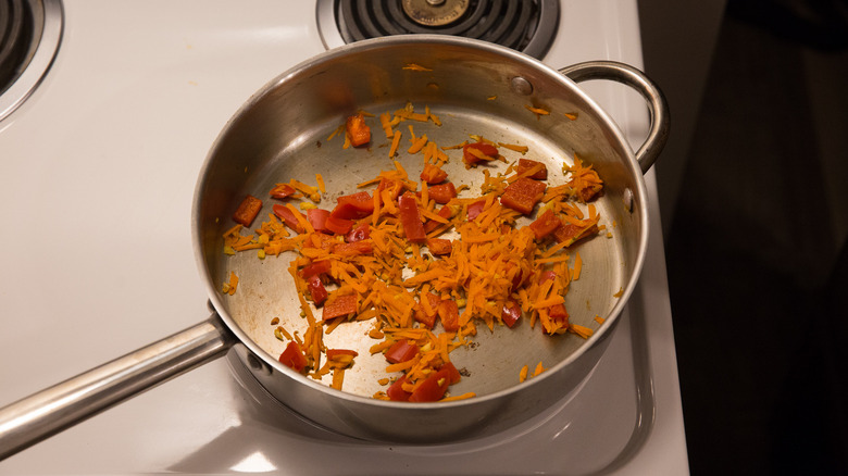 vegetables sauteing in large pan