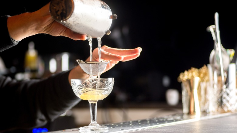 bartender pouring cocktail