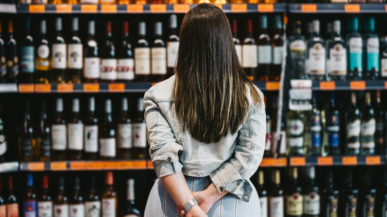 woman looking at wine labels