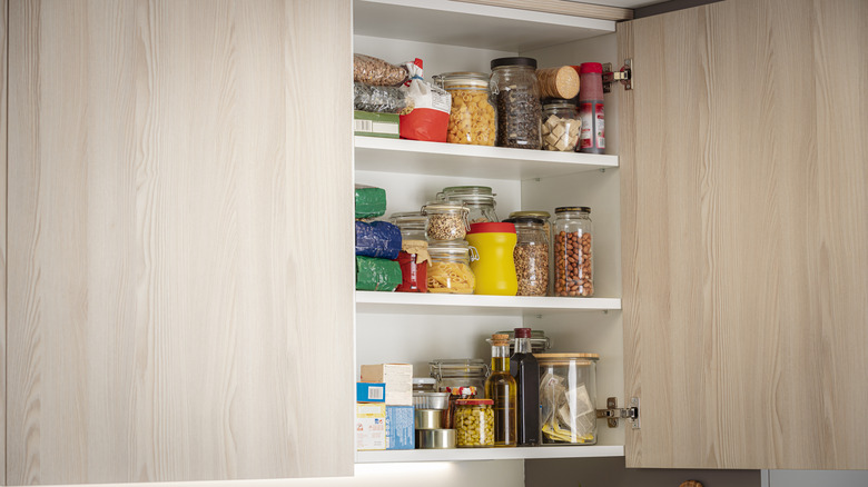 An open pantry with doors