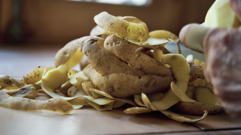 view of a pile of potato skins that have been peeled on a kitchen counter