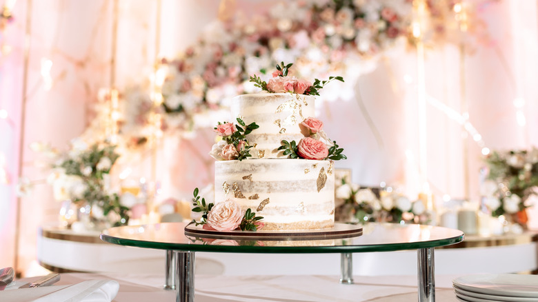 Two-tier wedding cake with pink flowers 