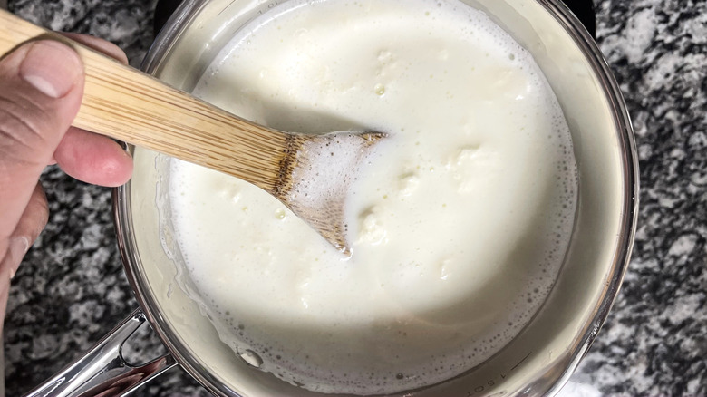 stirring hot curdled milk