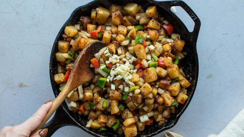 potatoes and peppers in skillet