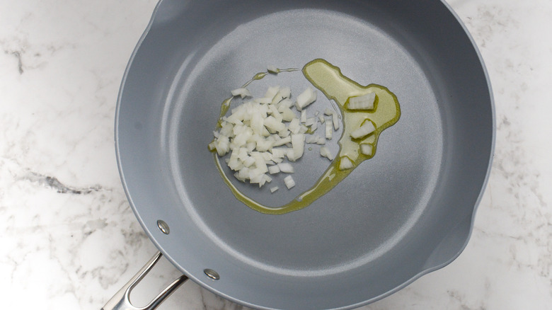 diced onion cooking in pan