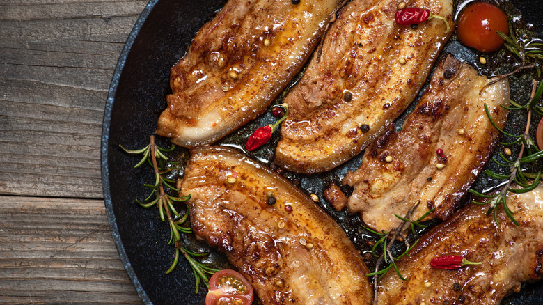 Fried bacon steaks with herbs and spices