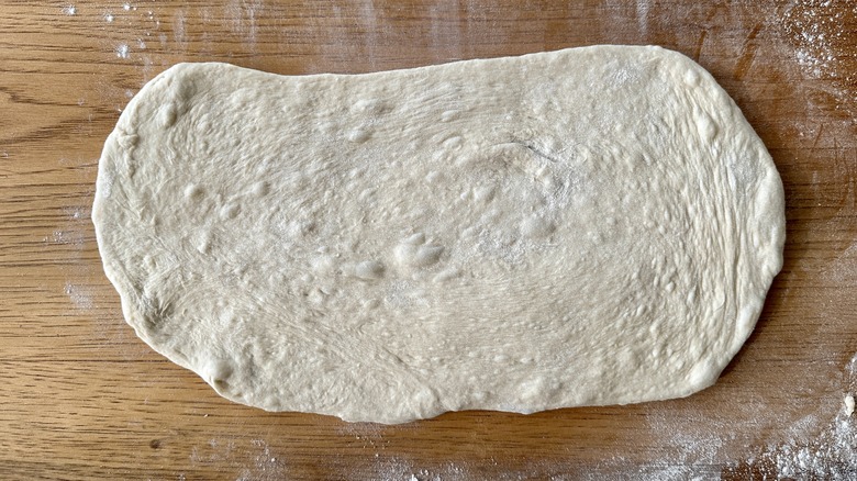 Rolled dough on floured surface