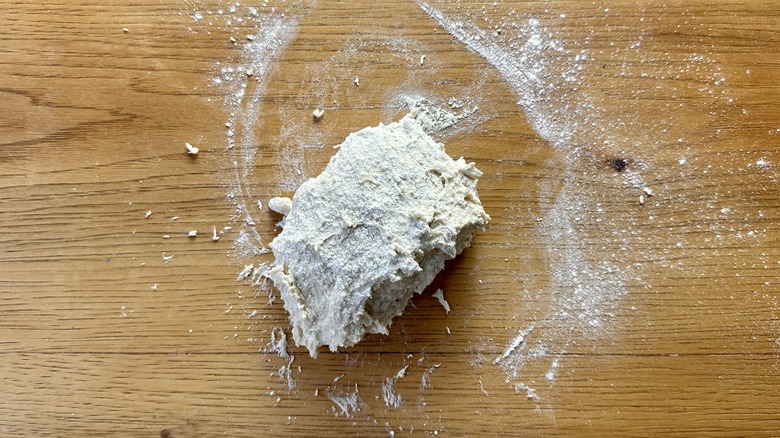 Flatbread dough on floured surface