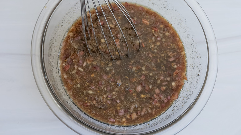 whisking marinade in bowl