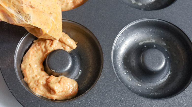 donut batter piping into pan