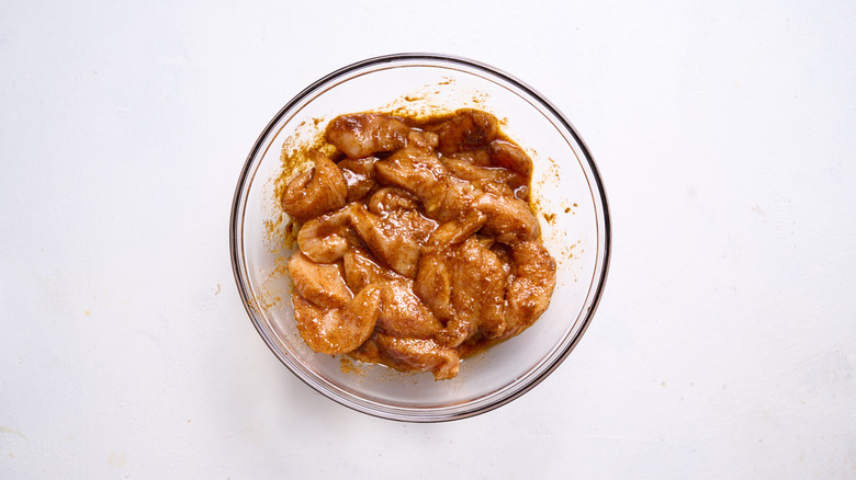 chicken marinating in bowl