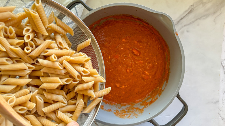 adding pasta to pot