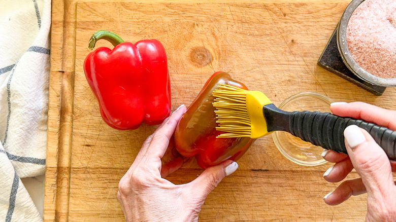 brushing a pepper with oil