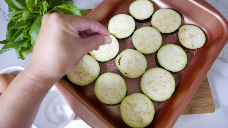 sprinkling eggplant with salt 