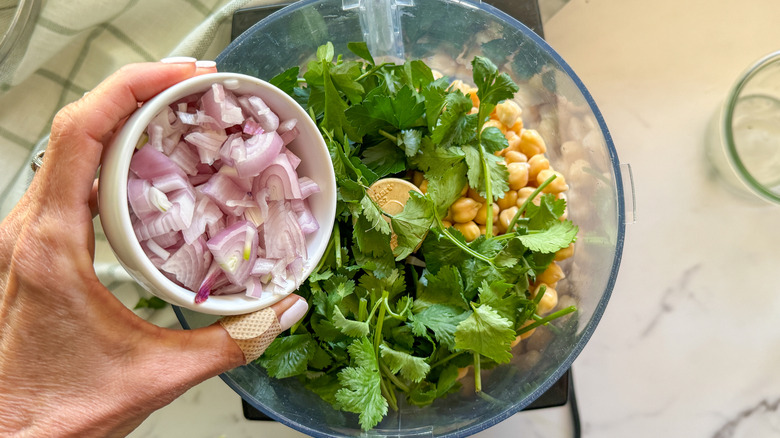 adding shallots to food processor