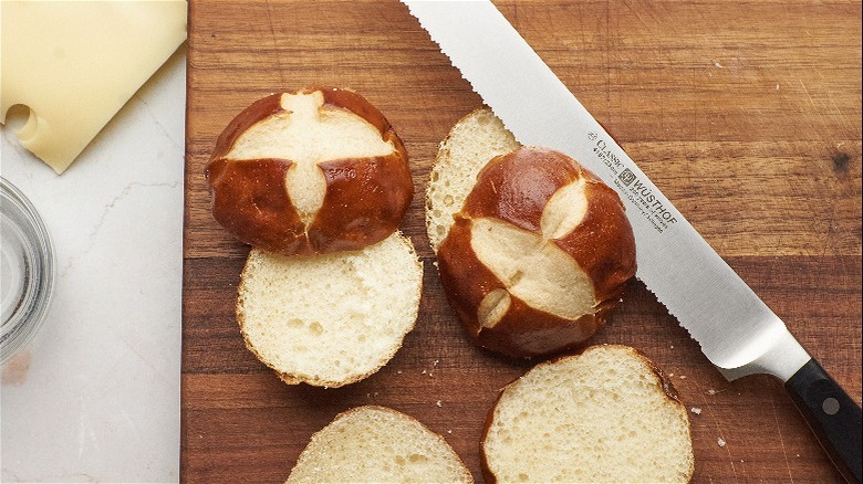 cutting pretzel buns with knife