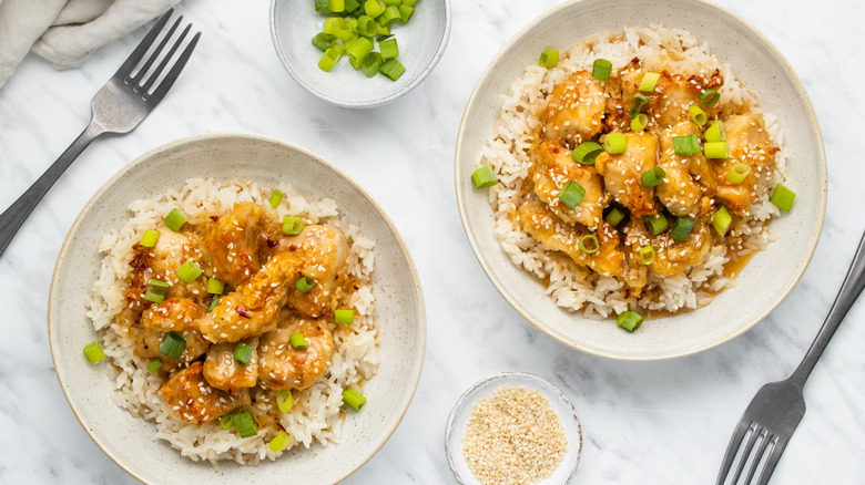 orange chicken in bowls 