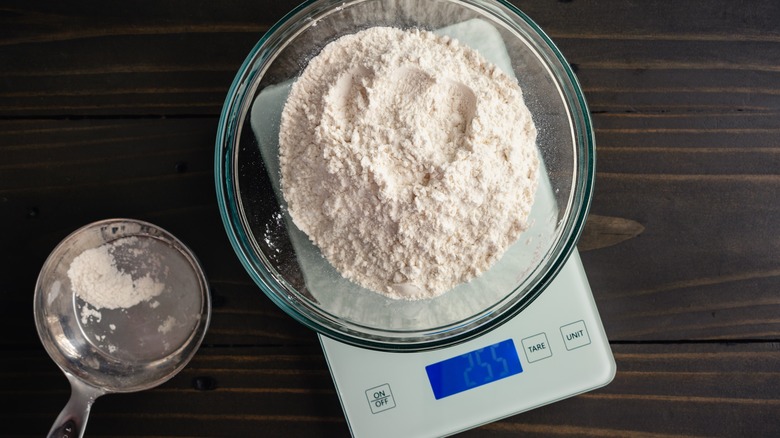 measuring cup and flour on scale