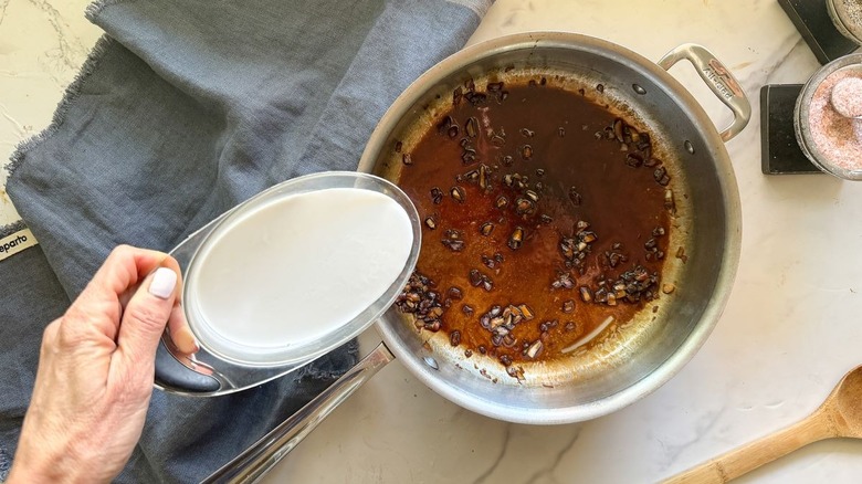 Cream being poured into balsamic vinegar