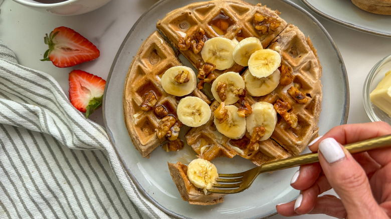 hand with fork and waffle