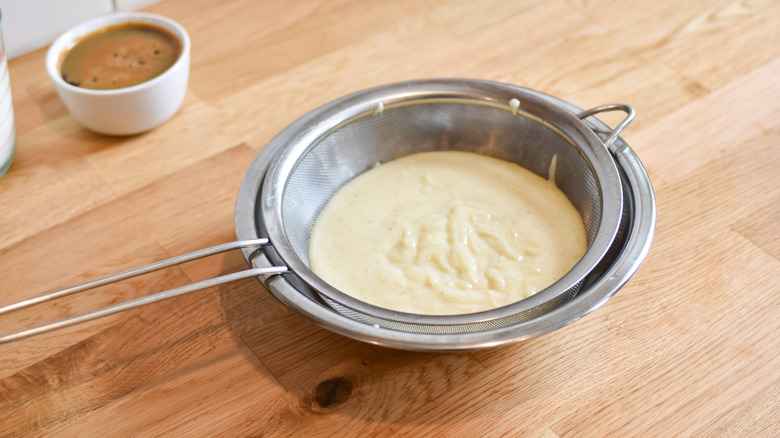 straining cooked pudding