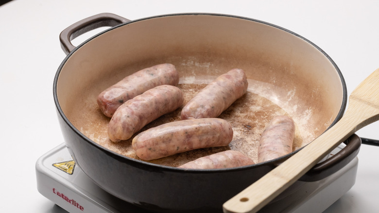 cooking sausages in a pan