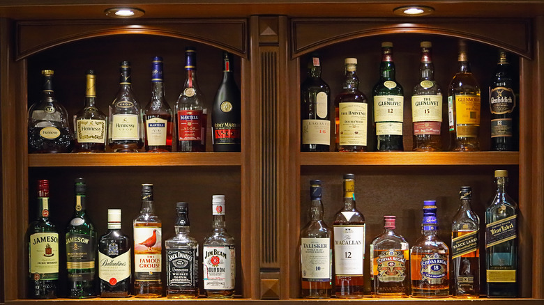 A lighted liquor cabinet showcasing a wide range of liquor bottles