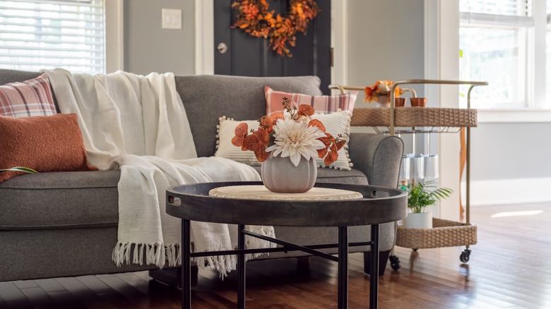 A living space shown with a bar cart situated beside a sofa