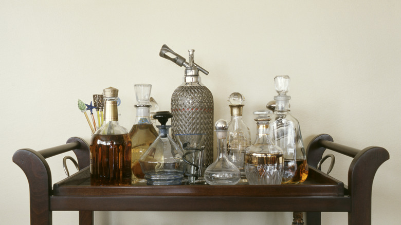 The top of a bar cart showing bottles of various shapes and sizes