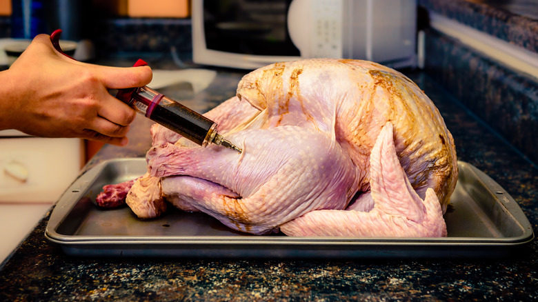 Injecting marinade into turkey