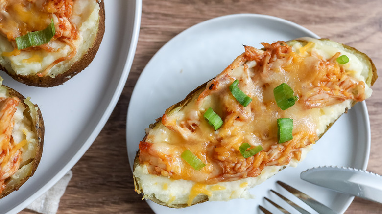 a barbecue chicken-stuffed twice-baked potato on a plate