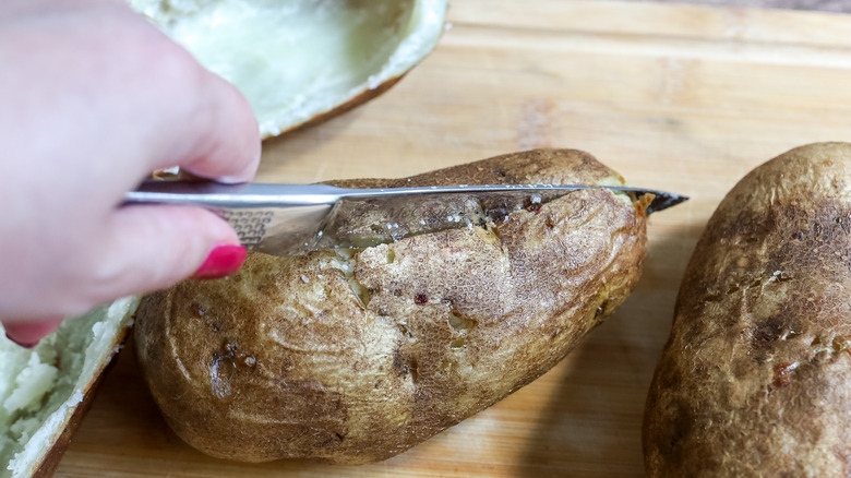 baked potatoes being cut in half